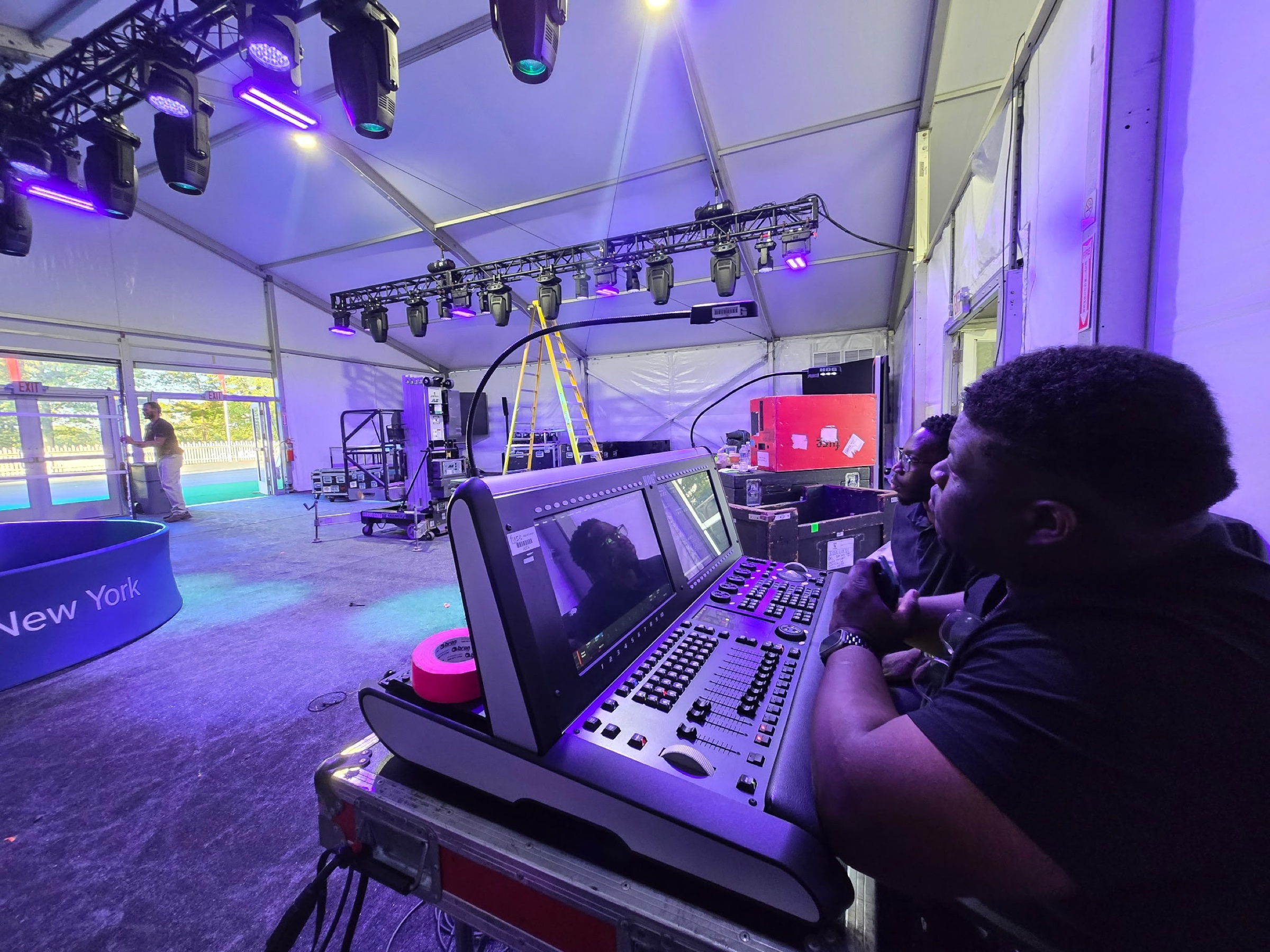A Rizen AV technician operating the video and lighting control position during the I LOVE NY activation