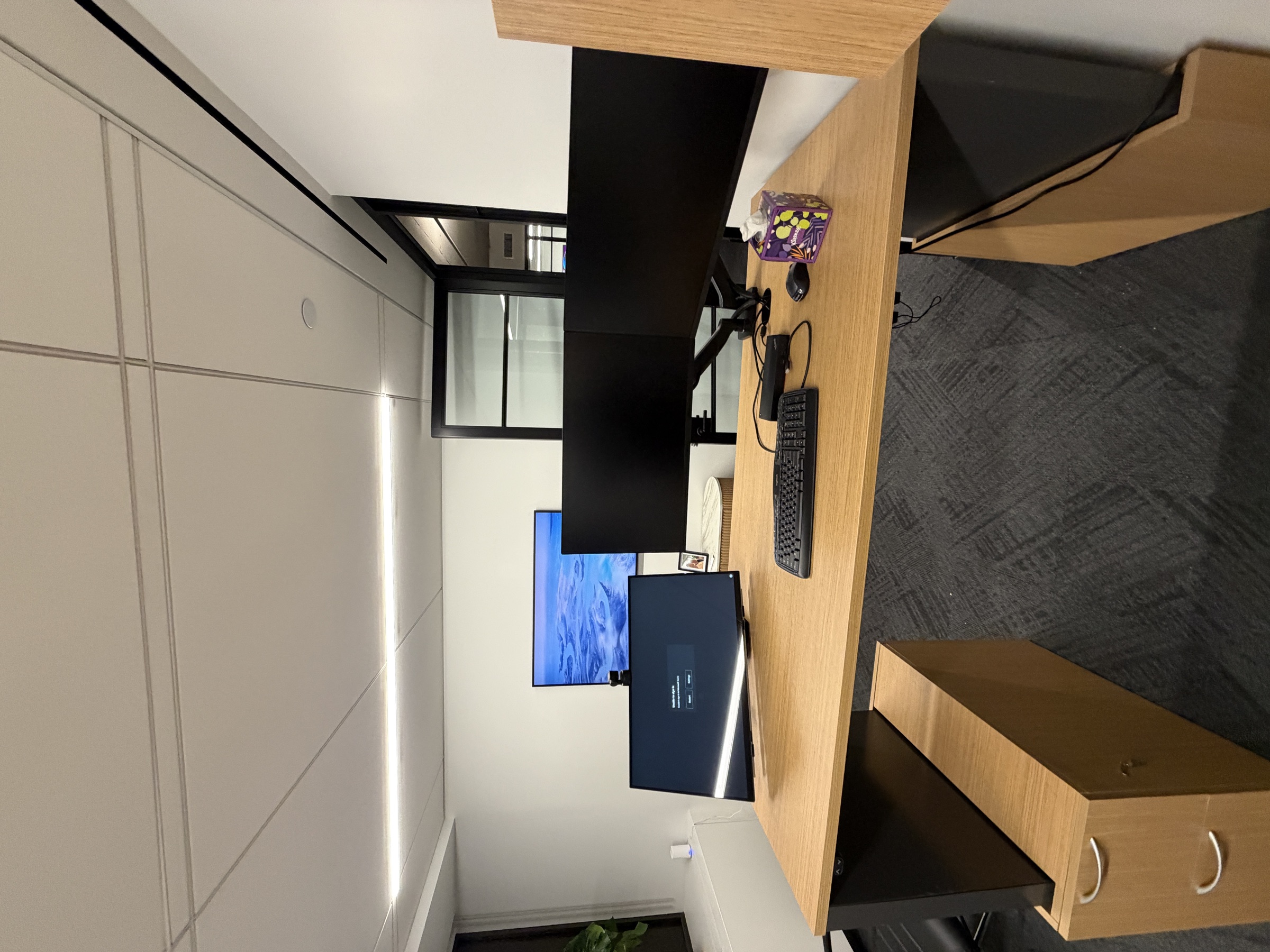 A completed TCG workstation with three monitors on desk mounts