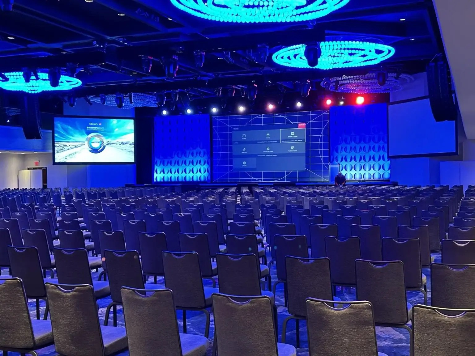 A professionally equipped presentation venue with integrated displays, lighting, and audio